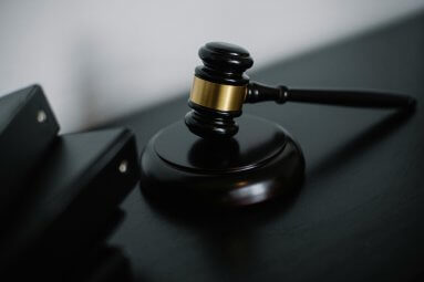 pexels-photo-5668473-5668473 Close-up of a wooden gavel on a desk, symbolizing justice and legal authority.