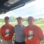 Neil Sullivan (left) and Brody Huff (right) spend time with Eagle head coach David Bradshaw during the IHSBCA Futures event.